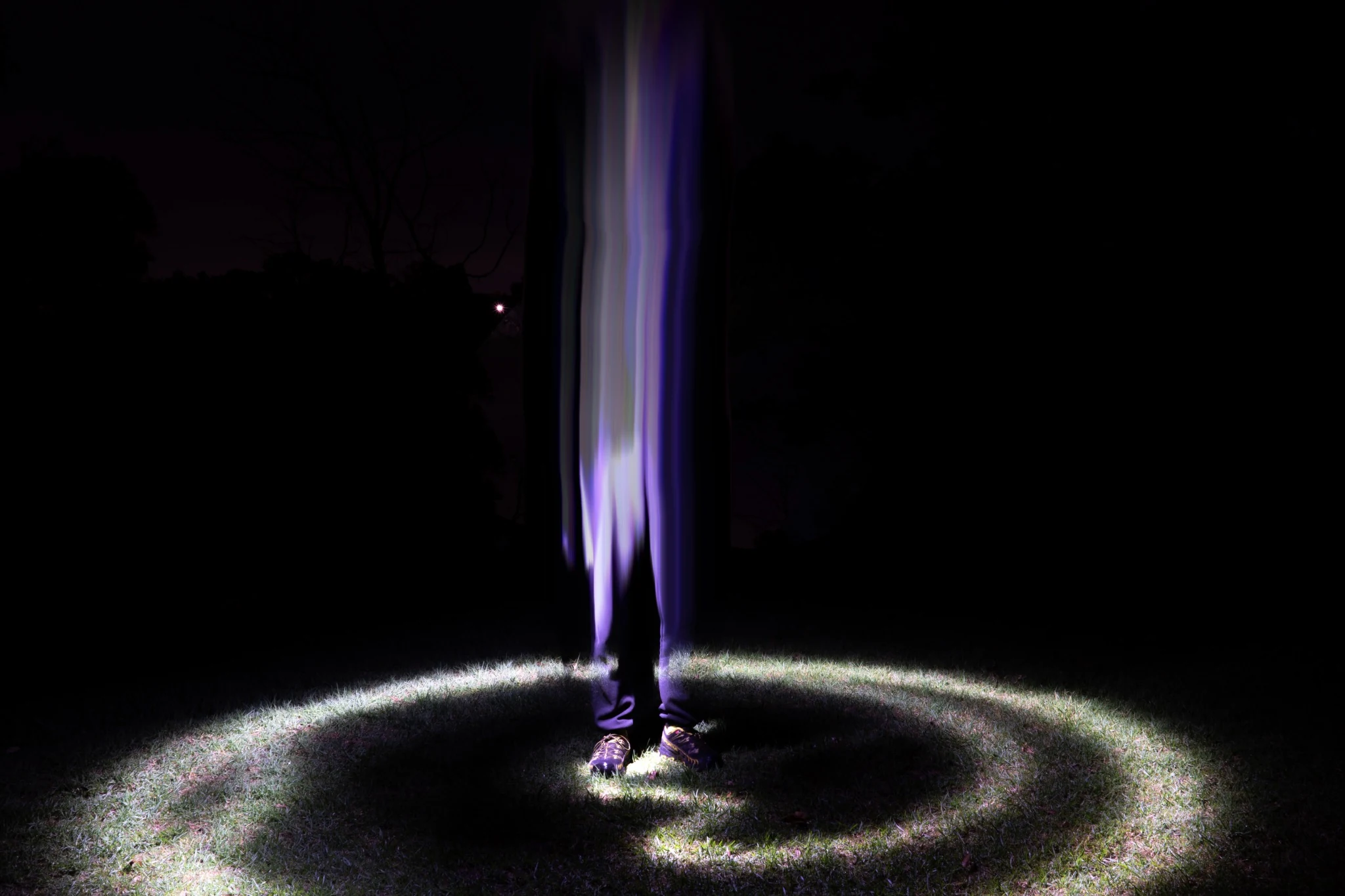 Vertical blurred body of light in a circular trail