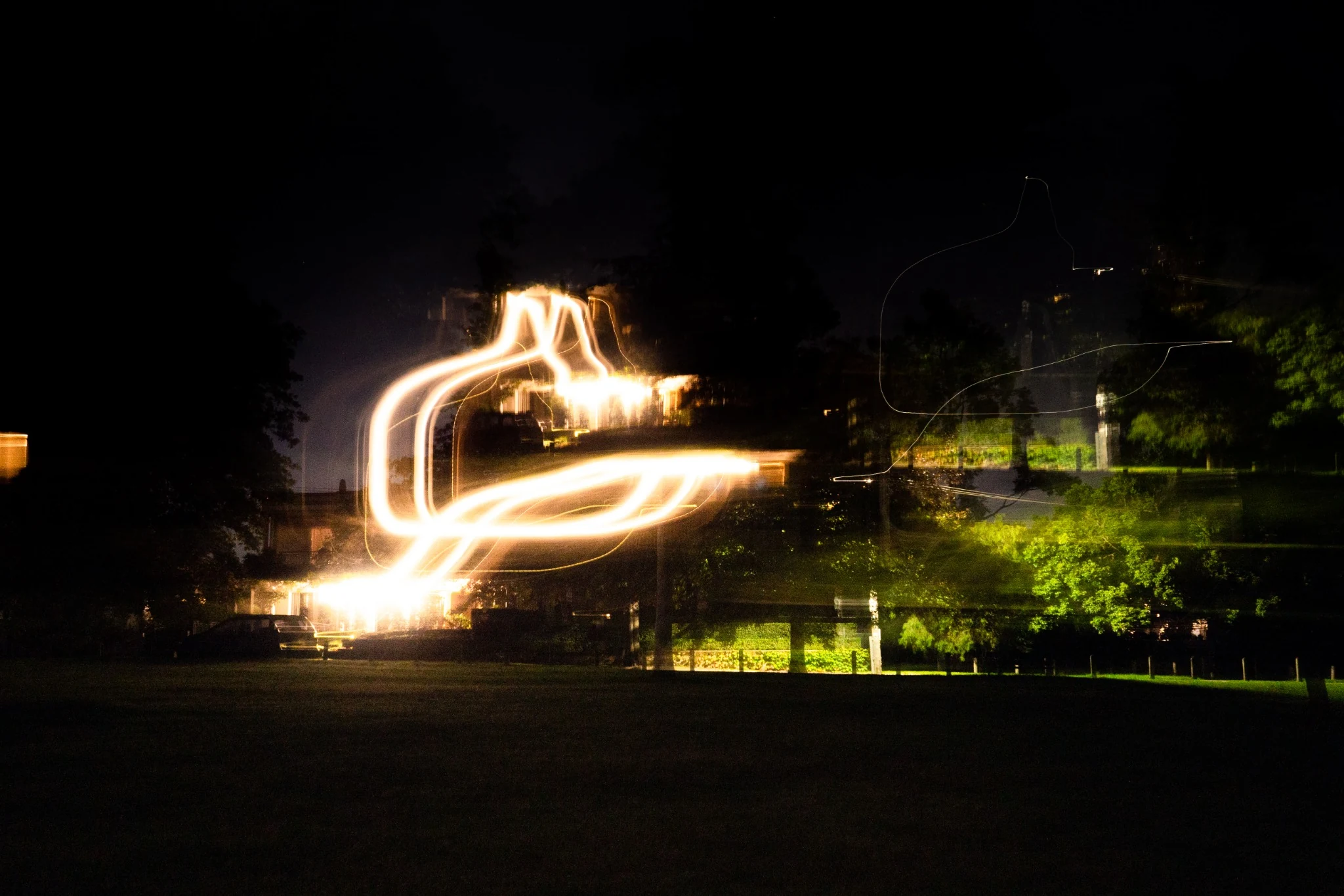 Abstract looping light shape in a dark field variation
